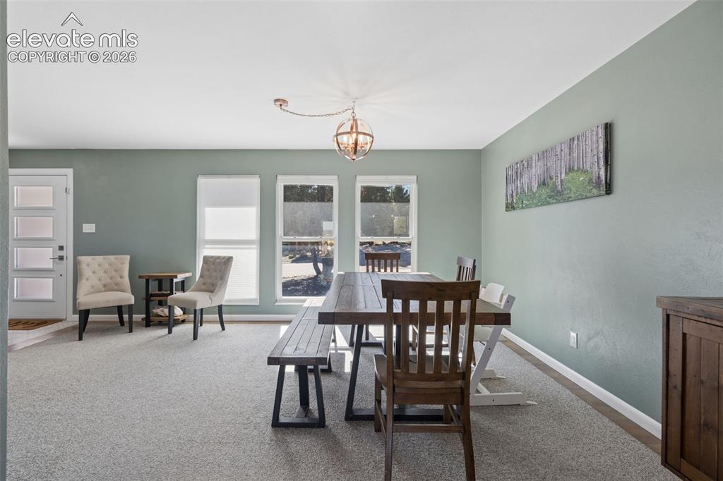 Image 23 of 49: Neutral-toned interior space featuring three large windows, a spherical met