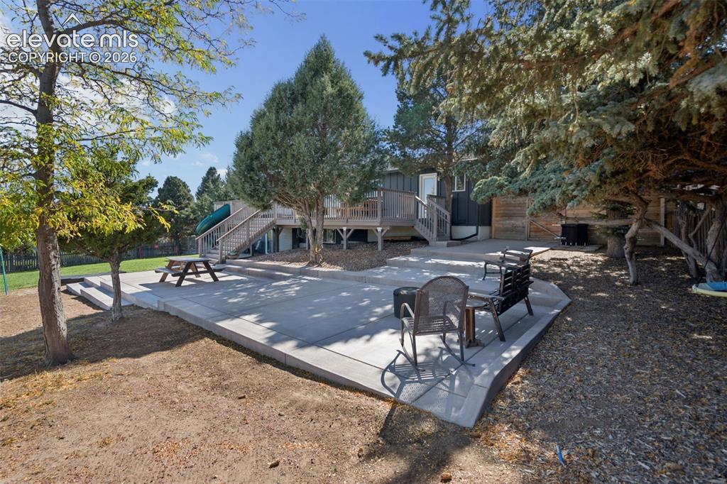 Image 37 of 49: Expansive concrete patio 