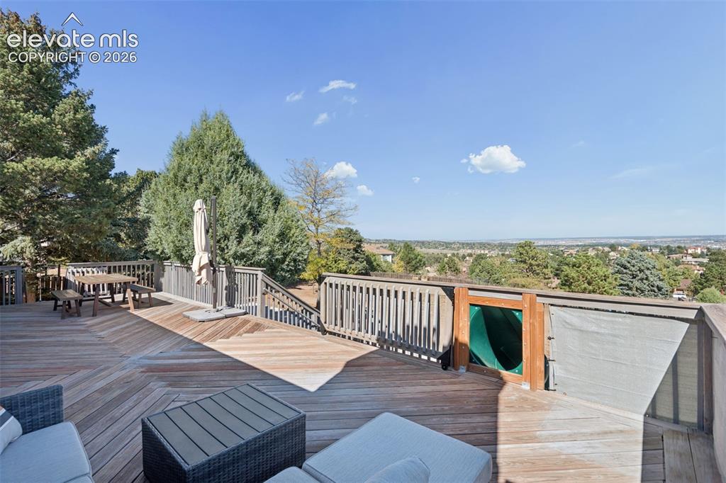 Image 41 of 49: Multi-level wood deck featuring herringbone-patterned decking, perimeter wo