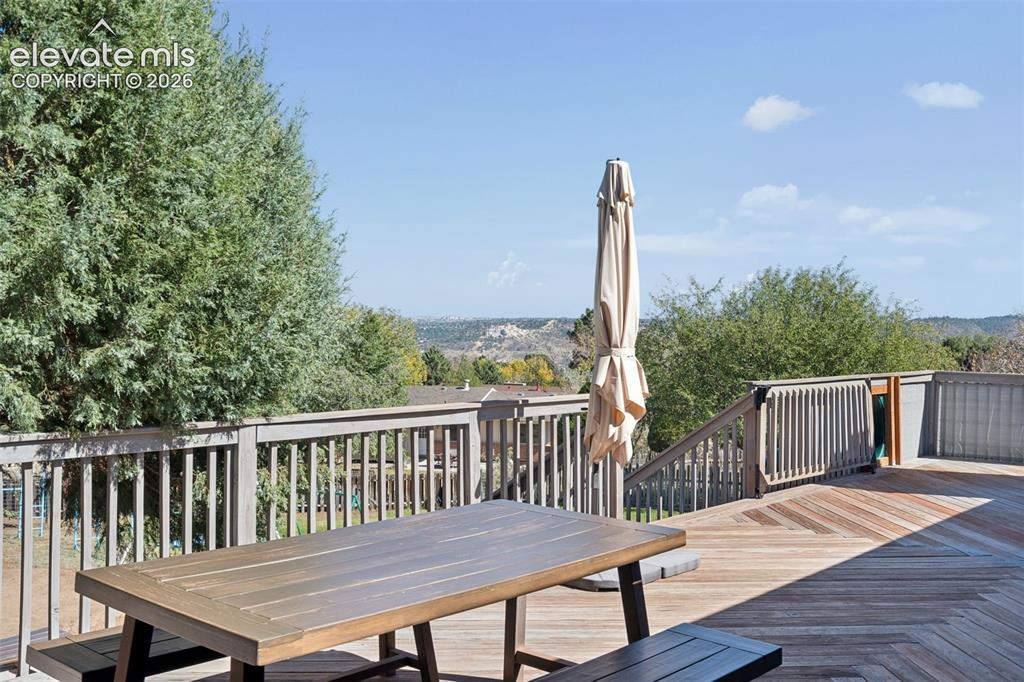 Image 42 of 49: Expansive elevated deck featuring herringbone-pattern wood-finish decking, 