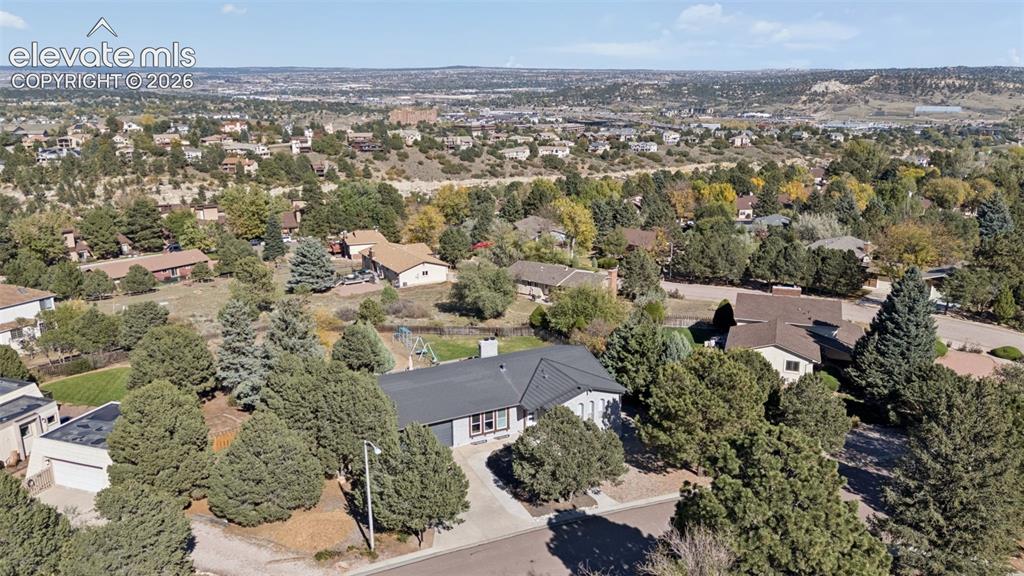 Image 47 of 49: Aerial perspective of a detached residence featuring a multi-gable roofline