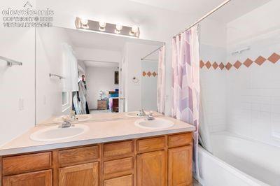 Image 29 of 49: The garden tub and dual sinks are luxurious! Virtually staged