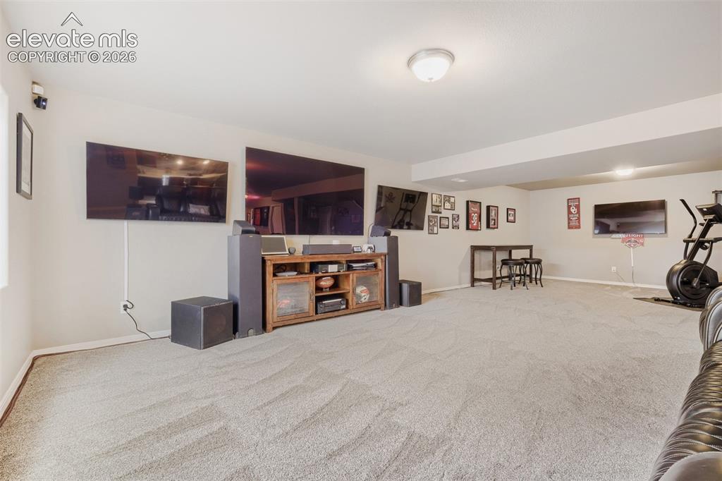 Image 20 of 31: Finished basement featuring a wet bar, spacious family room, two bedrooms,