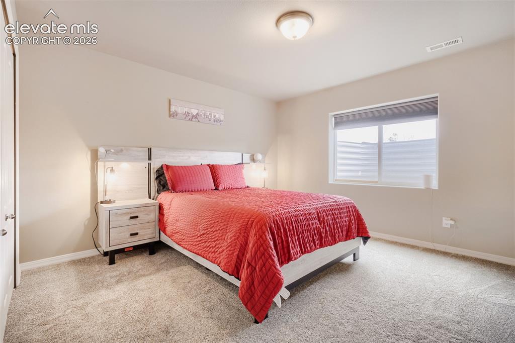 Image 25 of 31: Basement 4th bedroom room featuring a white ceiling, light gray walls, and