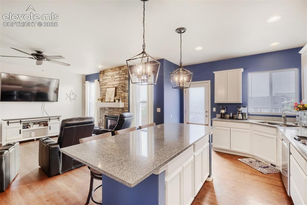 Image 7 of 31: Gormet kitchen featuring a large solid stone central island with seating, w