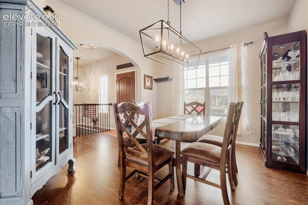 Image 9 of 31: Kitchen with white cabinetry, granite countertops, walk in pantry and stain