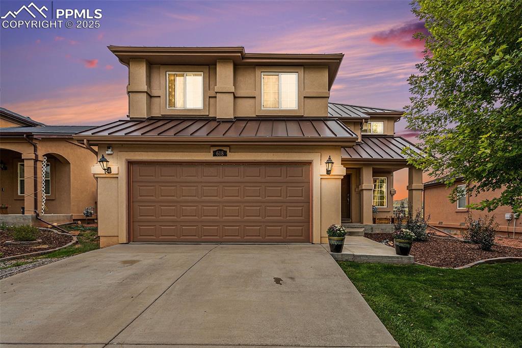 Caption: Stucco exterior, 2 car garage and landscaped front yard.