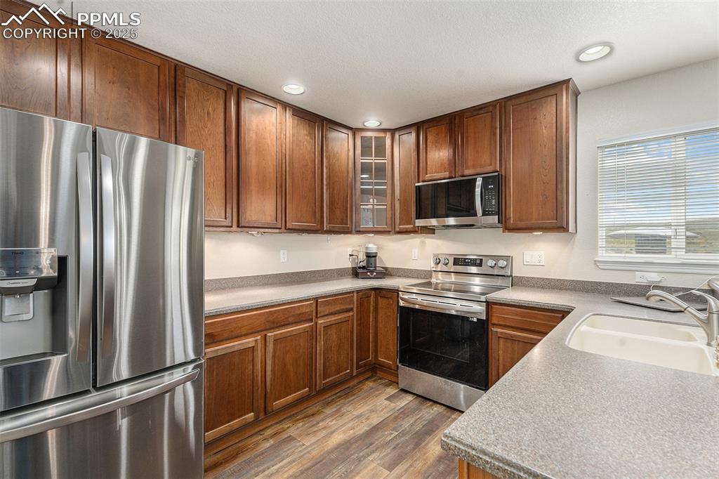 Image 13 of 30: kitchen with newer stainless steel appliances.