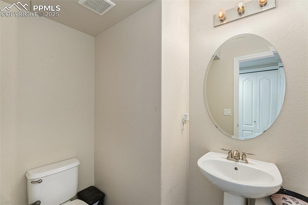 Image 16 of 30: down stairs powder room.