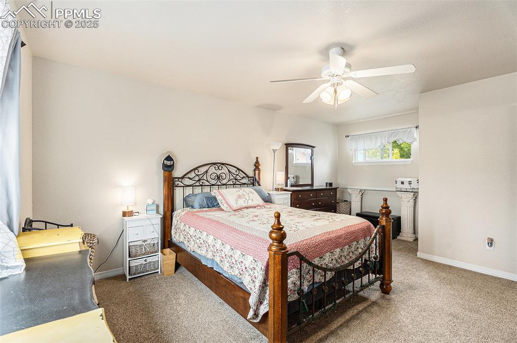 Image 19 of 30: Carpeted bedroom featuring ceiling fan and baseboards