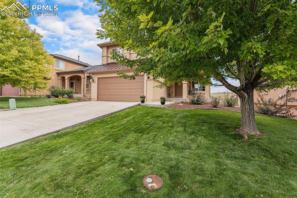 Image 5 of 30: View of front facade featuring a standing seam roof, a metal roof, a front