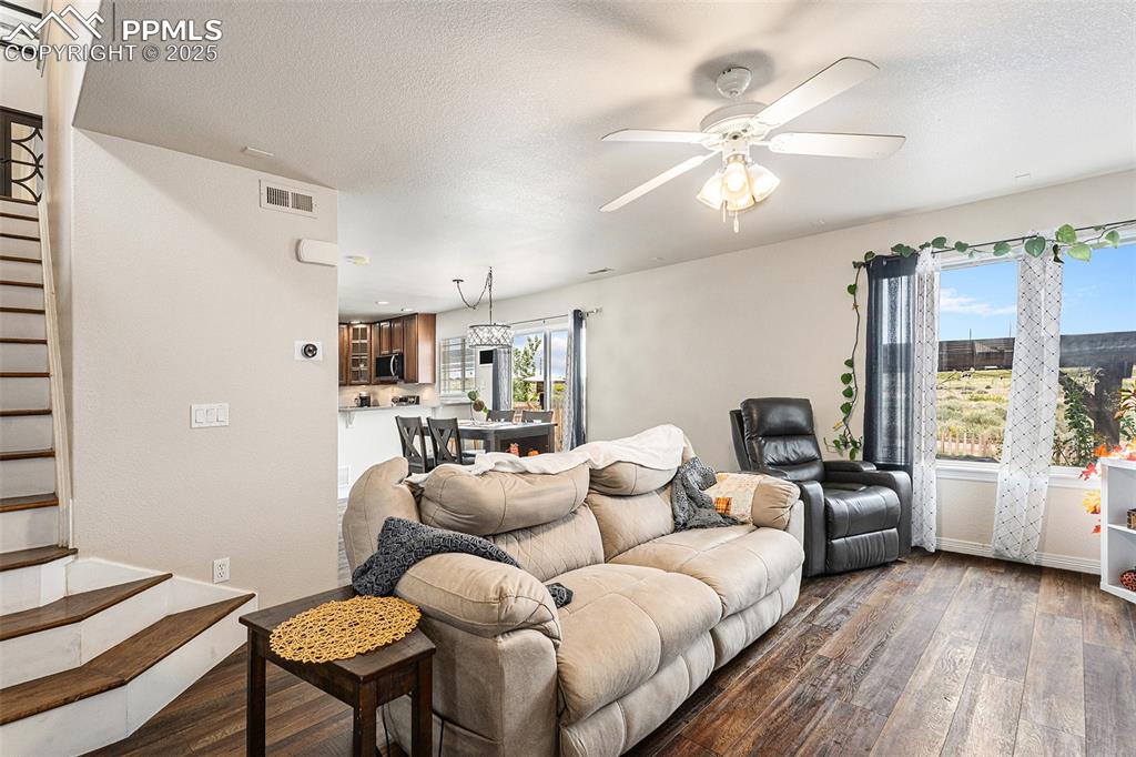 Image 6 of 30: living room front entry, stairway to upstairs bedrooms