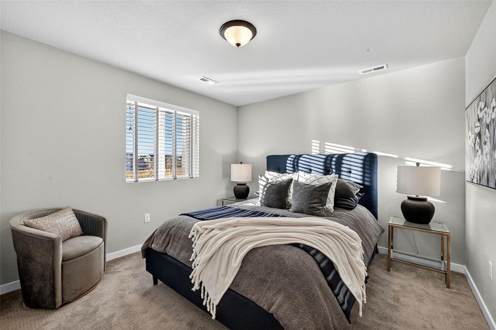Image 23 of 32: Lower level bedroom with en-suite bathroom