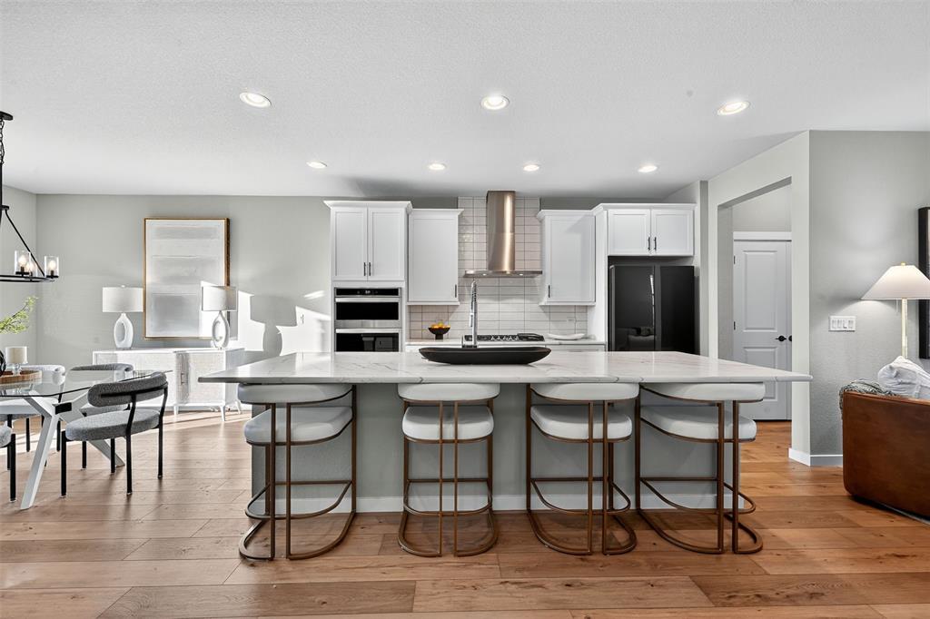 Image 5 of 32: Large eat-in kitchen with updated cabinets and quartz countertops