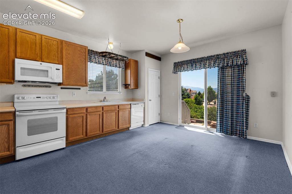 Image 12 of 46: Eat-In Country Style Kitchen and Walk-Out to the Patio and Backyard