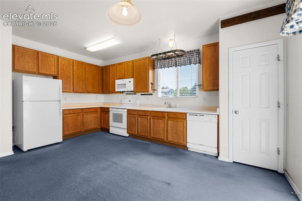 Image 13 of 46: Eat-In Country Style Kitchen with Sizable Pantry and Plenty of Cooking and 