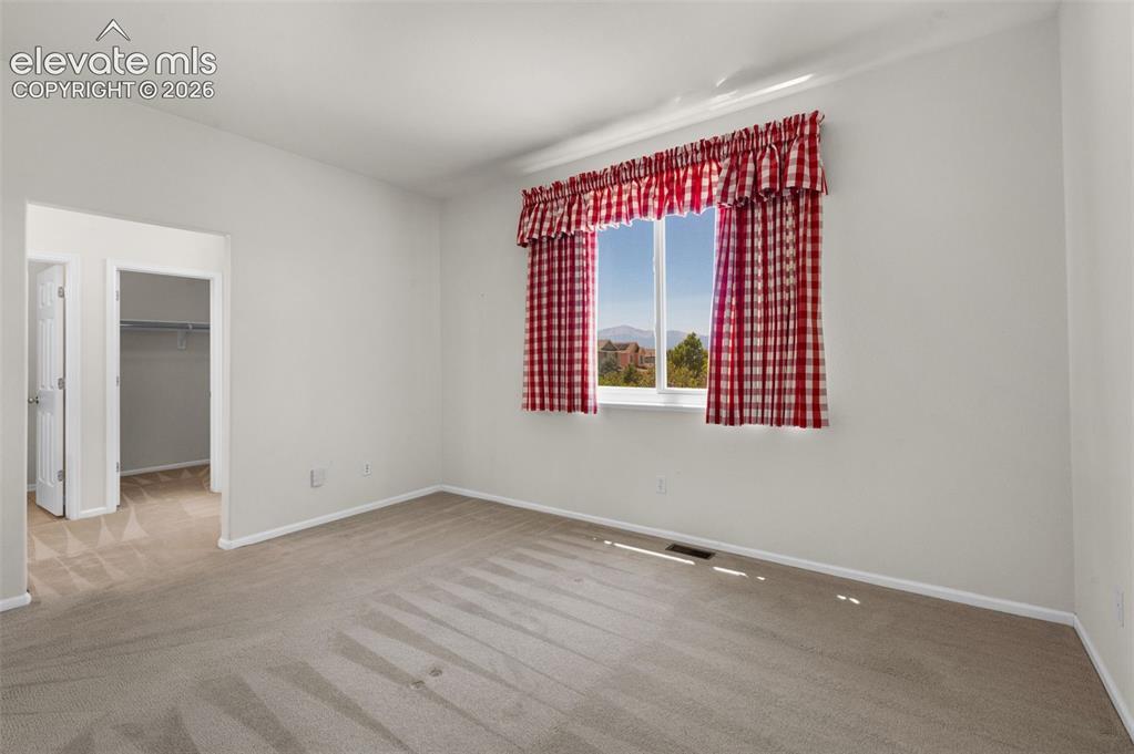 Image 15 of 46: Primary Bedroom Showing Entry to the Walk-In Closet and Bathroom
