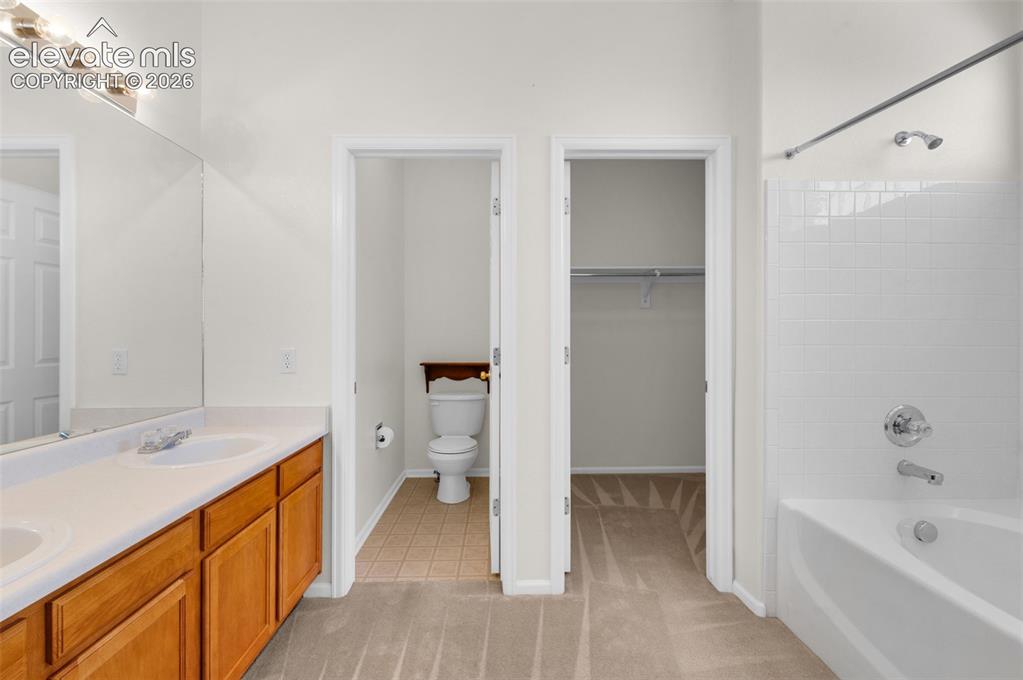 Image 17 of 46: Primary Bathroom Featuring Double Vanity, Tub/Shower, Commode Room and Walk