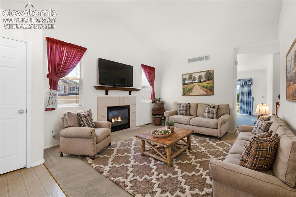 Image 2 of 46: Virtually Staged Photo... Living Room and Entry Featuring Gas Log Fireplace