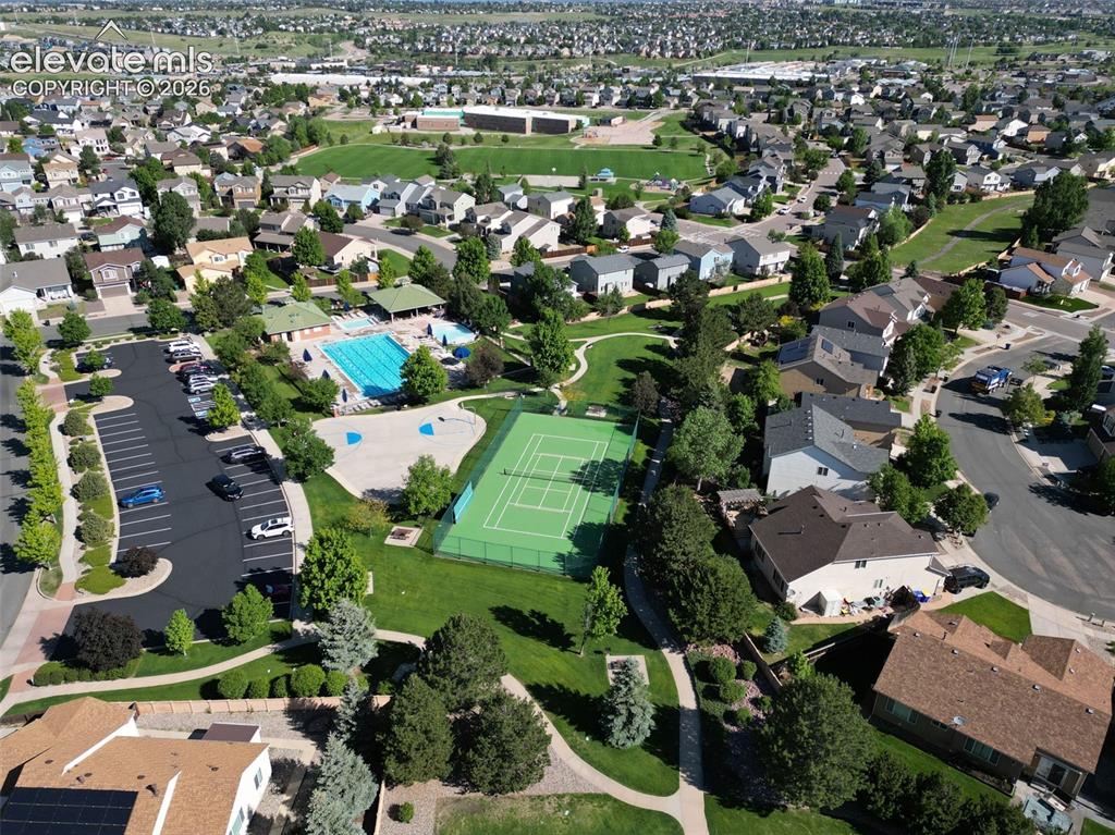 Image 43 of 46: Aerial View of the Pool, Tennis & Basketball Courts, Green Spaces, and Walk
