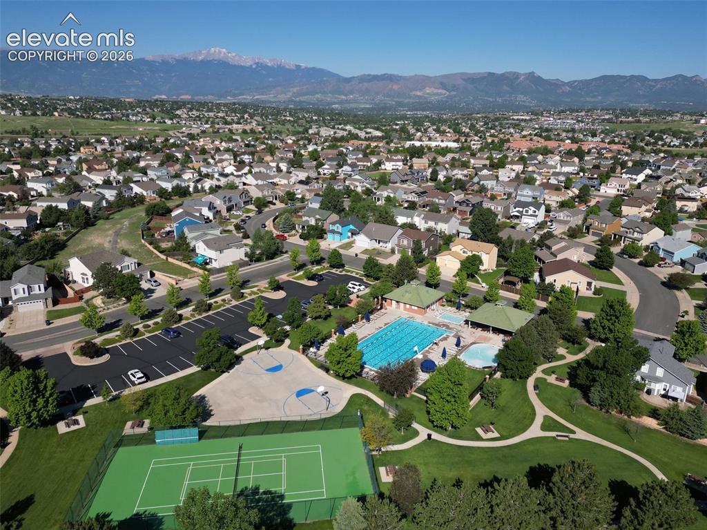 Image 44 of 46: Aerial View of the Pool, Tennis & Basketball Courts, Green Areas, and Walki