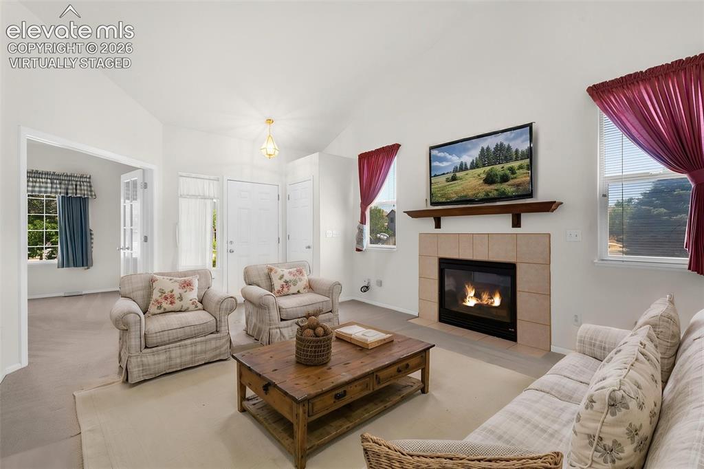 Image 7 of 46: Virtually Staged Photo... Living Room and Entry Showing French Doors Into T