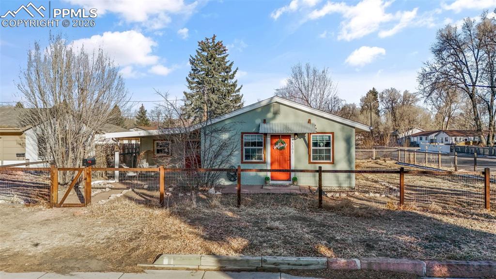 Caption: View of front facade featuring a fenced front yard