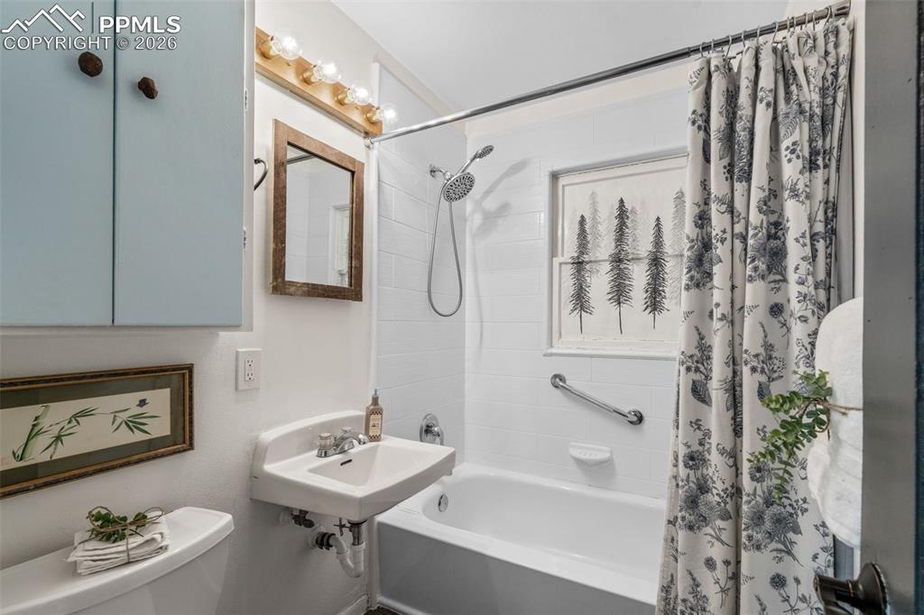 Image 13 of 37: Bathroom with shower / tub combo with curtain and toilet