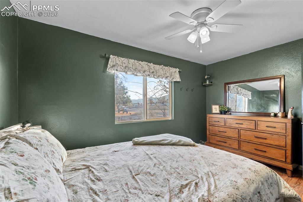 Image 15 of 37: Bedroom featuring a textured wall and ceiling fan