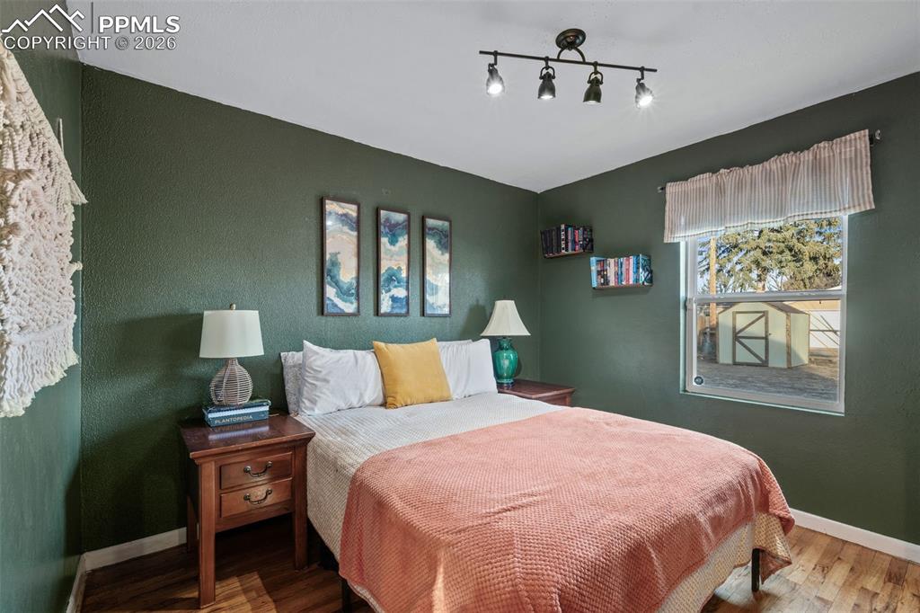 Image 21 of 37: Bedroom with baseboards and wood finished floors
