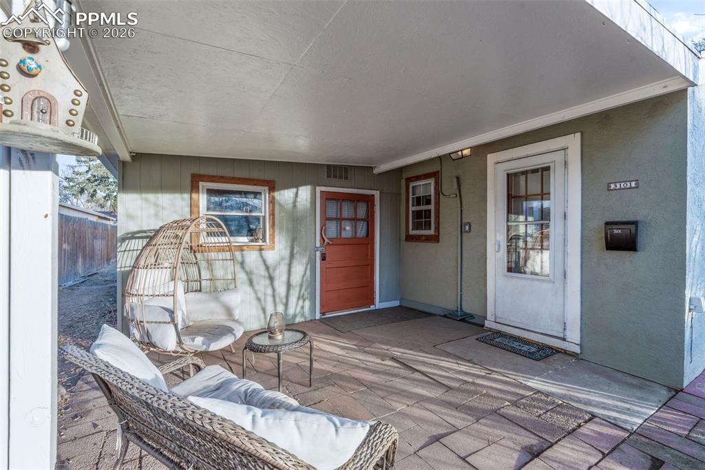 Image 24 of 37: View of exterior entry featuring a patio