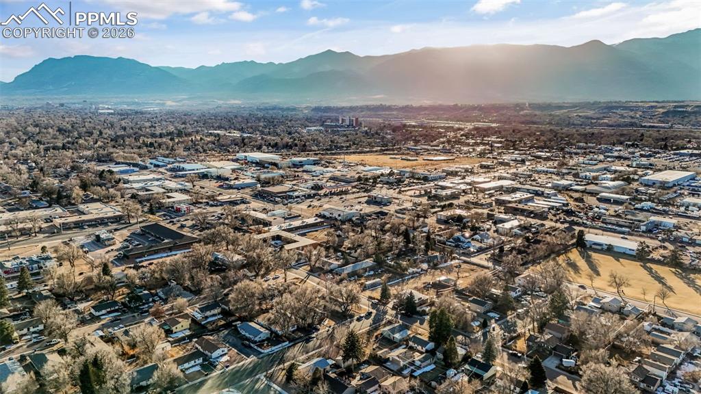 Image 33 of 37: View of property location with a mountain backdrop and nearby suburban area