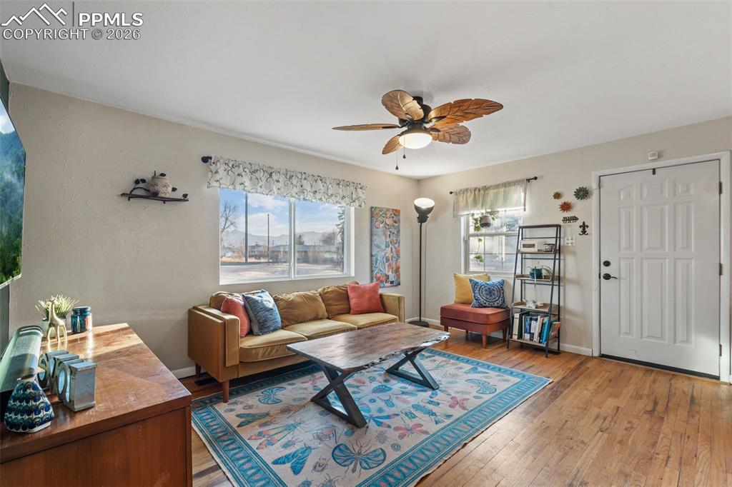 Image 7 of 37: Living area with wood-type flooring and a ceiling fan