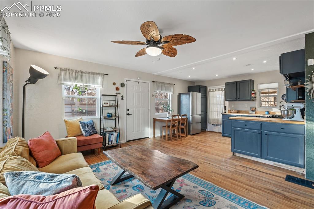 Image 8 of 37: Living area featuring light wood-style flooring, ceiling fan, and recessed 