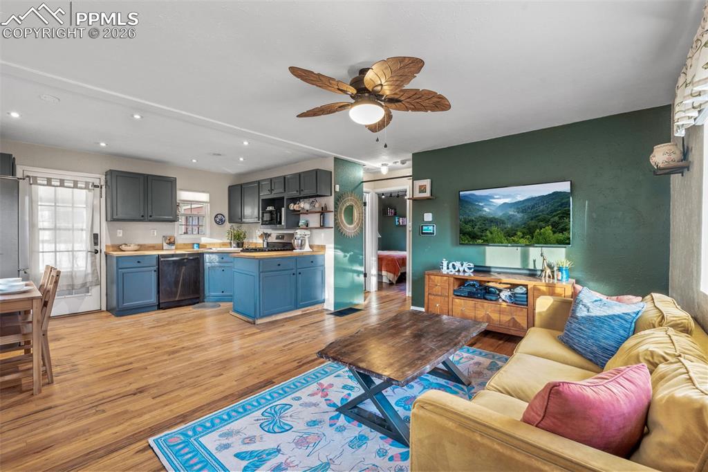 Image 9 of 37: Living room featuring ceiling fan, light wood-style flooring, and recessed 