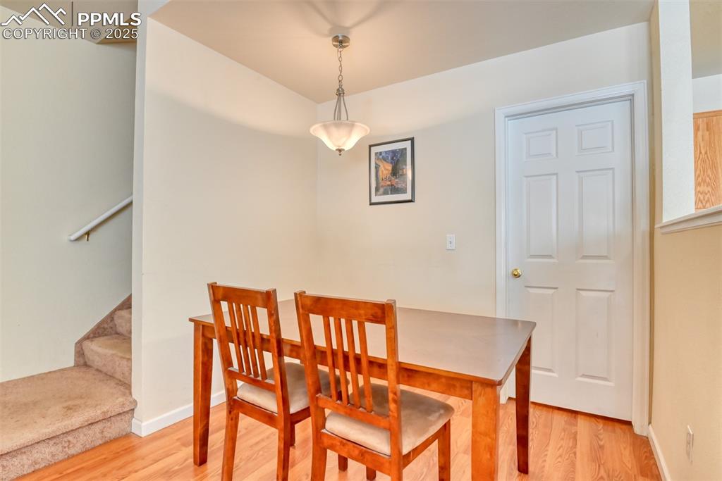 Image 13 of 32: Dining room featuring light wood-style floors and stairs