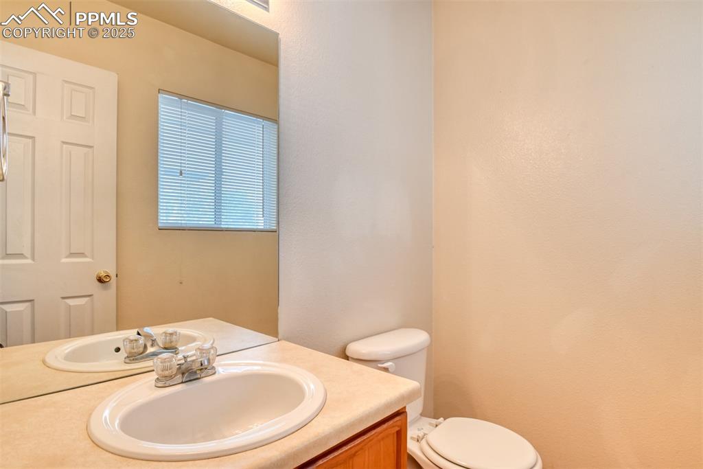 Image 19 of 32: Half bathroom featuring toilet and vanity