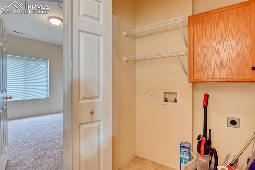 Image 21 of 32: Washroom with electric dryer hookup, washer hookup, and light colored carpe
