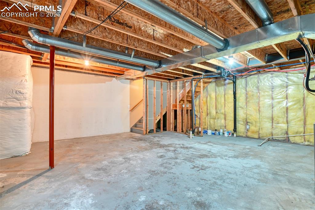 Image 30 of 32: Unfinished basement with stairs