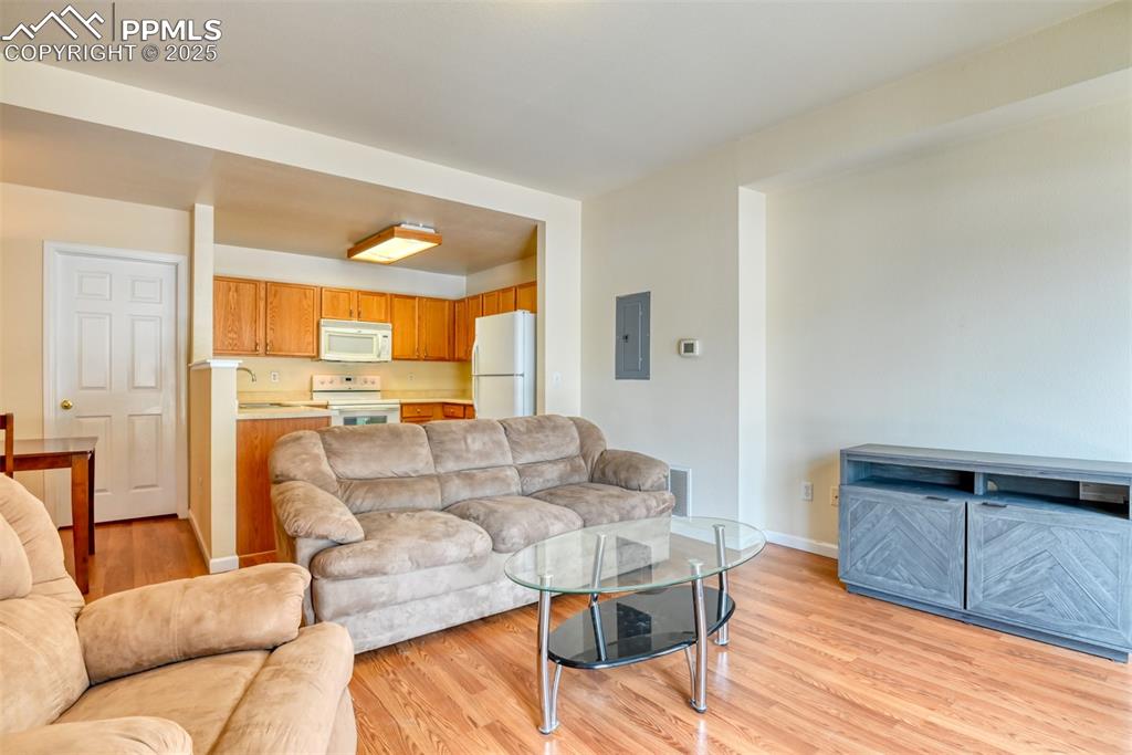 Image 7 of 32: Living area featuring electric panel and light wood-type flooring