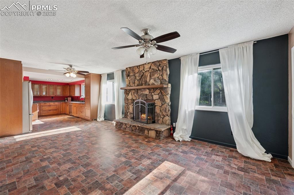 Image 11 of 41: Unfurnished living room featuring healthy amount of natural light, ceiling 