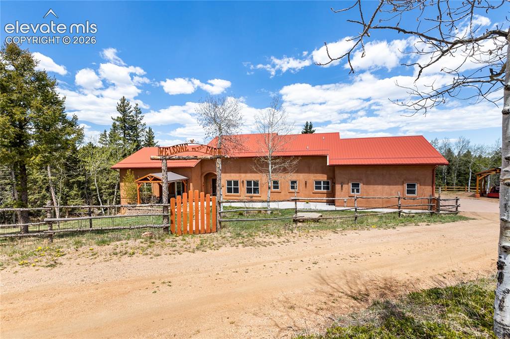 Image 1 of 40: Stunning stucco home on a beautifully treed mountain property!