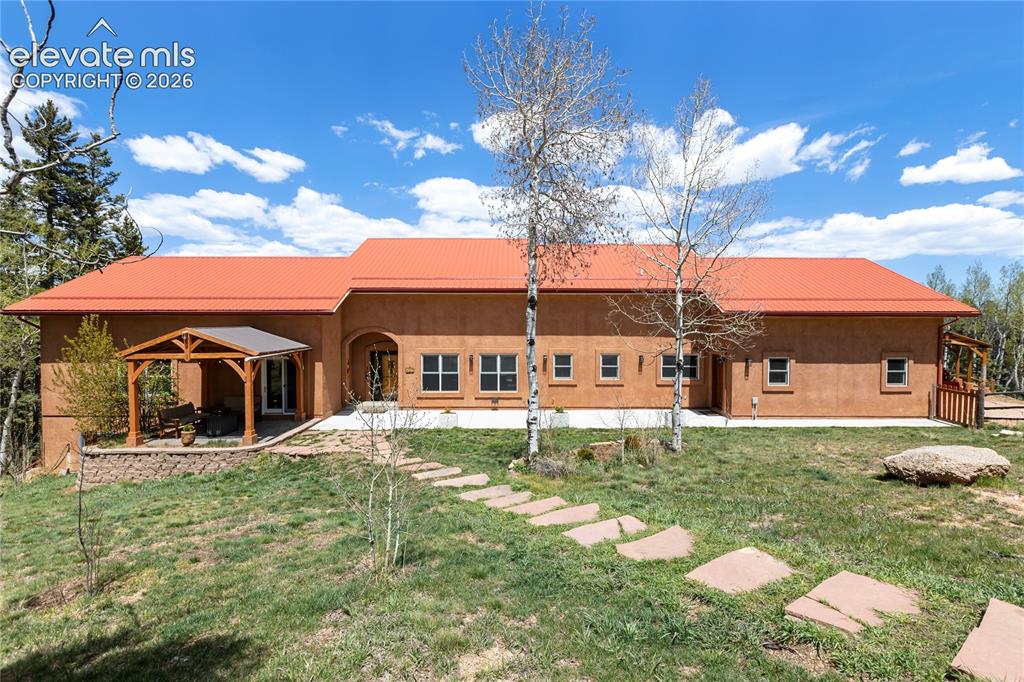 Image 2 of 40: Stunning stucco home on a beautifully treed mountain property!