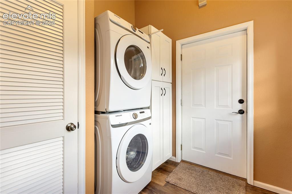 Image 26 of 40: Convenient laundry area with built-in cabinetry!