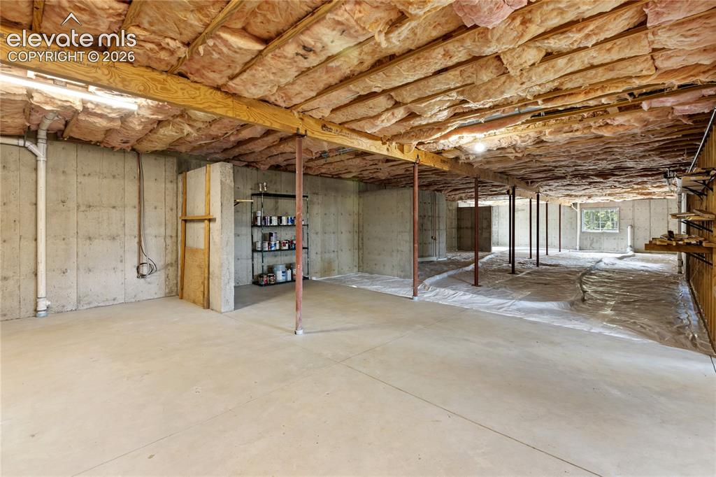 Image 29 of 40: Unfinished basement with approximately one-quarter finished with concrete f