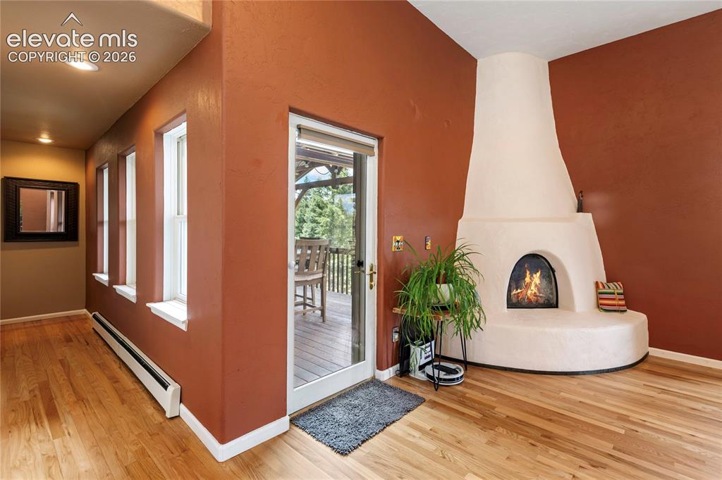 Image 7 of 40: Southwestern-style Kiva fireplace with a rounded hearth and arched firebox