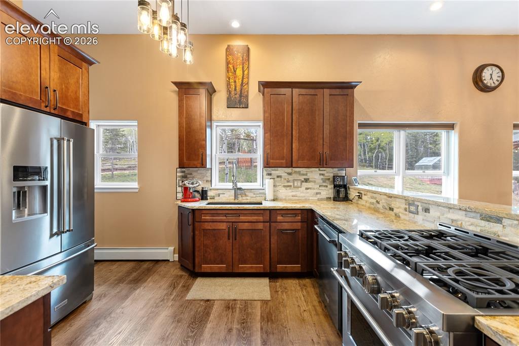 Image 8 of 40: Gourmet kitchen with custom cabinetry, granite countertops, and newer stain