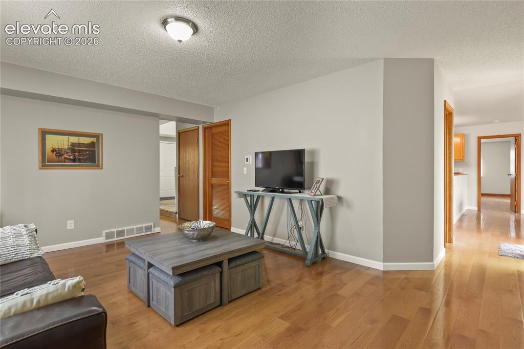 Image 10 of 50: Main level family room with view toward slider to deck