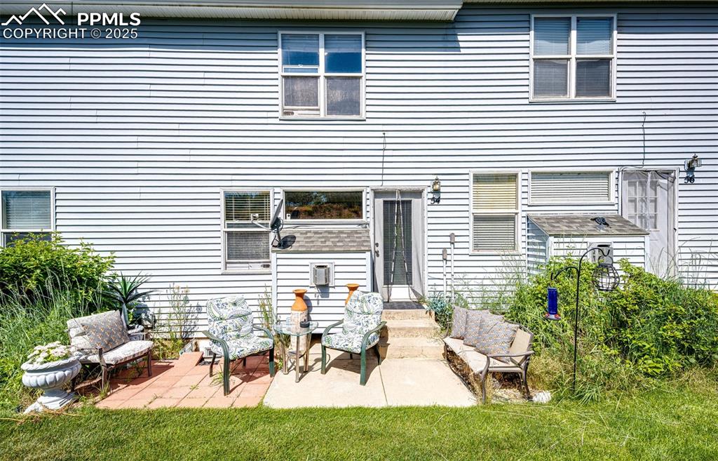 Image 25 of 34: Back of property with a patio