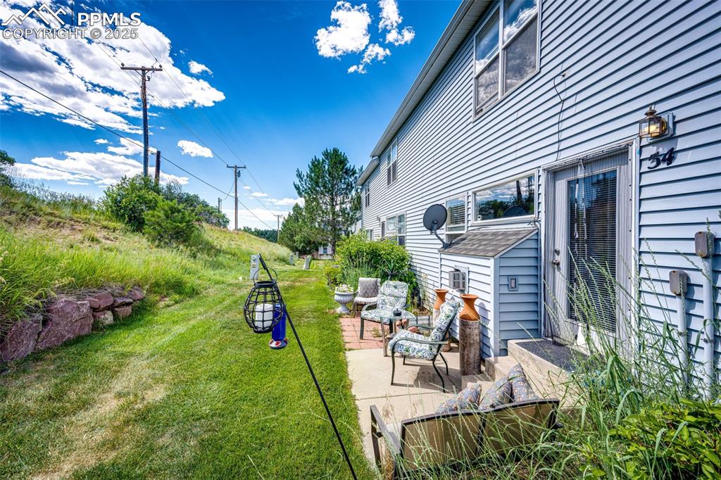 Image 26 of 34: View of grassy yard with a patio